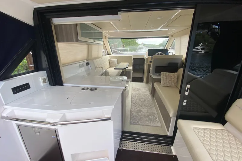 Slide: The Image of Interior view of a 2021 Regal 38 XO yacht, featuring modern seating and sleek design. - 29