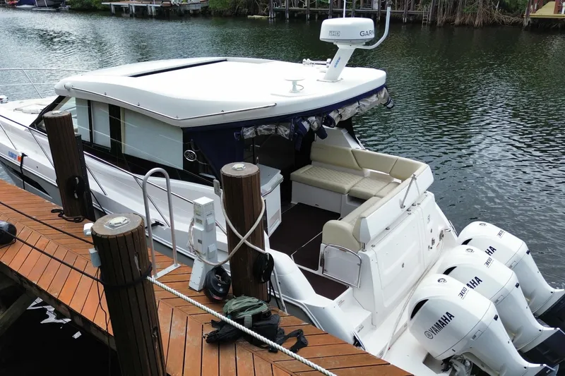 Slide: The Image of 2021 Regal 38 XO boat docked with Yamaha engines, featuring a sleek design and spacious seating. - 3