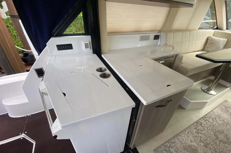 Slide: The Image of Luxurious interior of 2021 Regal 38 XO yacht with modern kitchenette and seating area. - 30