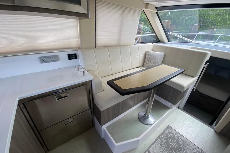 Slide: The Image of 2021 Regal 38 XO yacht interior with modern seating and dining area. - 32