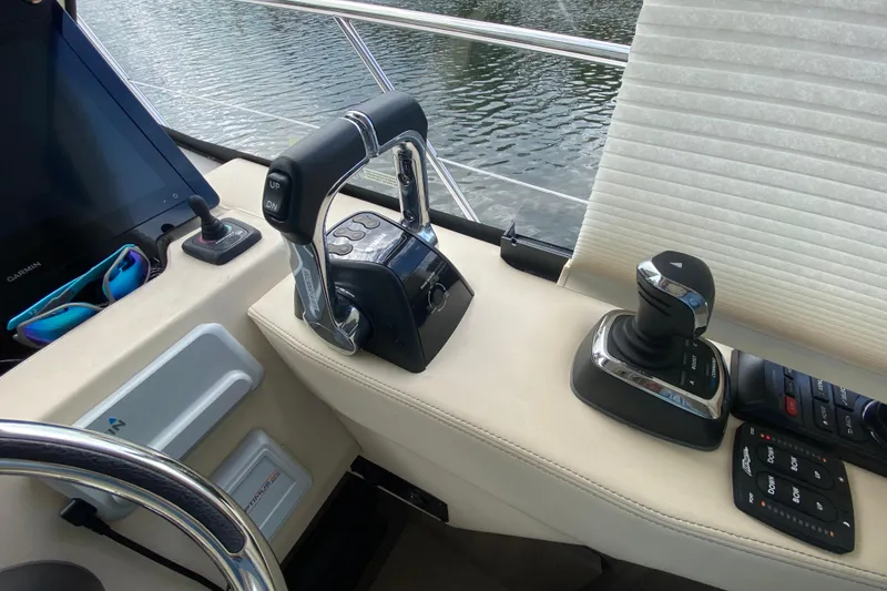 Slide: The Image of Control panel of a 2021 Regal 38 XO yacht with throttle and joystick. - 36