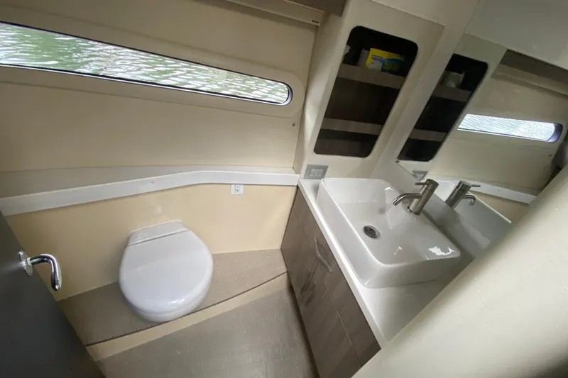 Slide: The Image of Bathroom interior of 2021 Regal 38 XO yacht, featuring modern sink and toilet. - 41