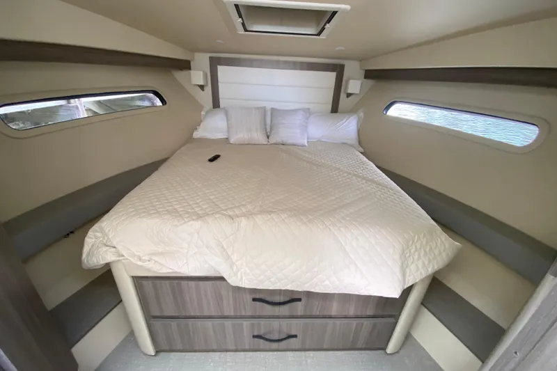 Slide: The Image of Cozy cabin interior of 2021 Regal 38 XO yacht with bed and storage drawers. - 42