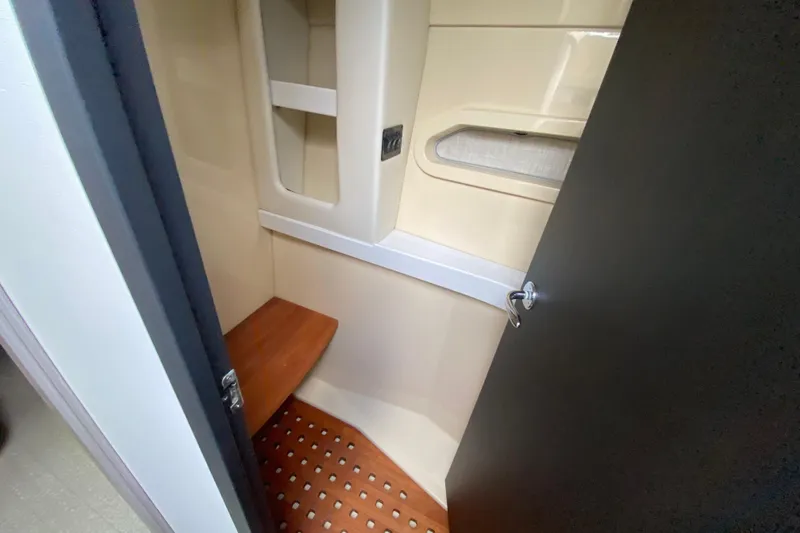 Slide: The Image of 2021 Regal 38 XO interior cabin with wooden bench and storage shelves. - 45