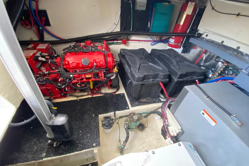 Slide: The Image of Engine room of 2021 Regal 38 XO boat with red engine and battery compartments. - 54
