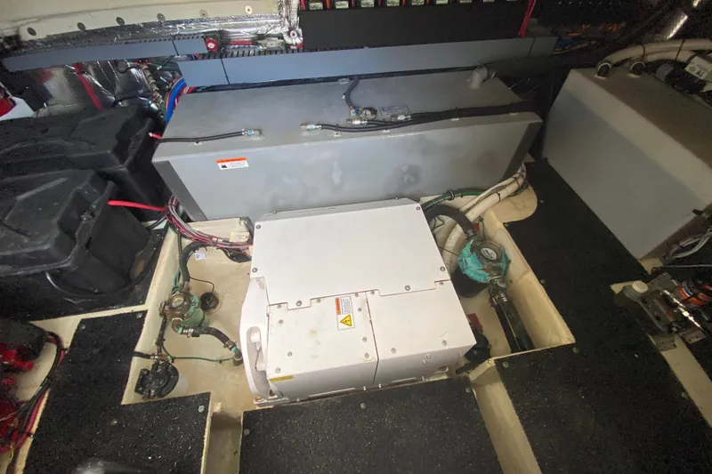 Slide: The Image of Engine room of 2021 Regal 38 XO boat, showcasing mechanical components and wiring. - 56