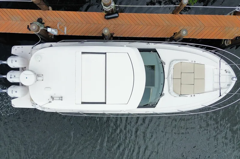 Slide: The Image of Aerial view of 2021 Regal 38 XO yacht docked at a wooden pier. - 62
