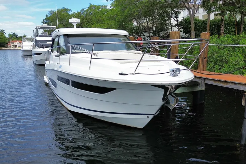 Slide: The Image of 2021 Regal 38 XO yacht docked on a serene waterway. - 9