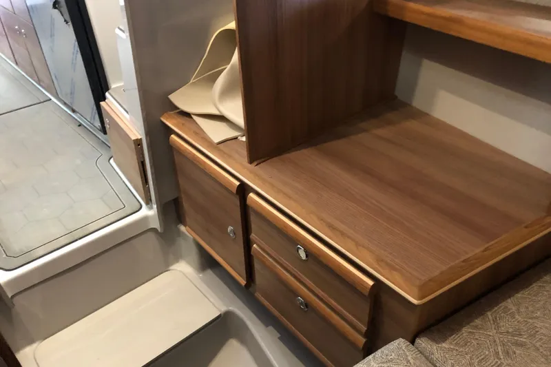 Slide: The Image of 2024 Ranger Tugs R-27 interior with wooden cabinetry and modern design elements. - 12