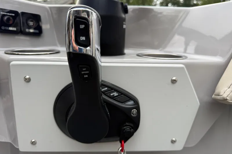 Slide: The Image of Throttle control panel of 2024 Ranger Tugs R-27 boat, featuring up and down buttons. - 21