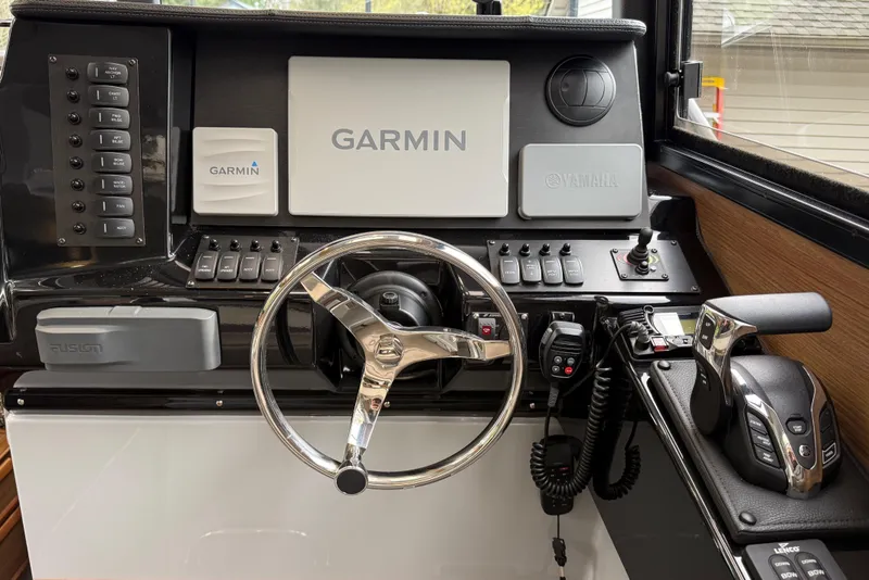 Slide: The Image of 2024 Ranger Tugs R-27 helm with Garmin navigation system. - 8