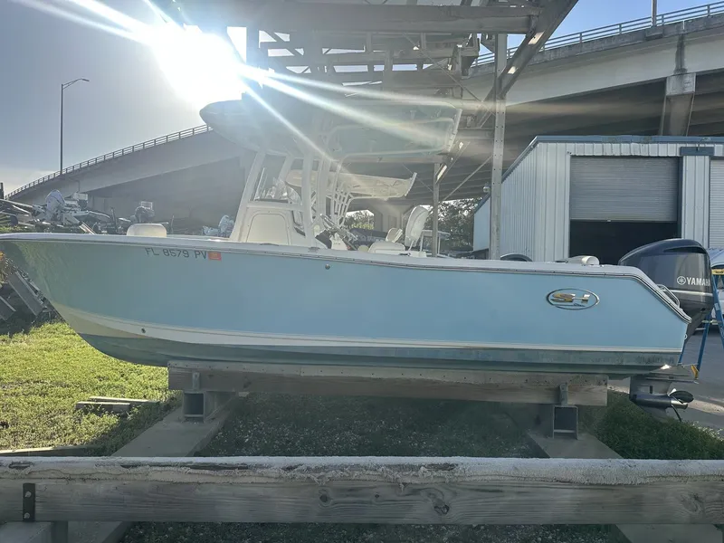 Slide: The Image of 2023 Sea Hunt Ultra 235 SE boat outdoors at sunset. - 7