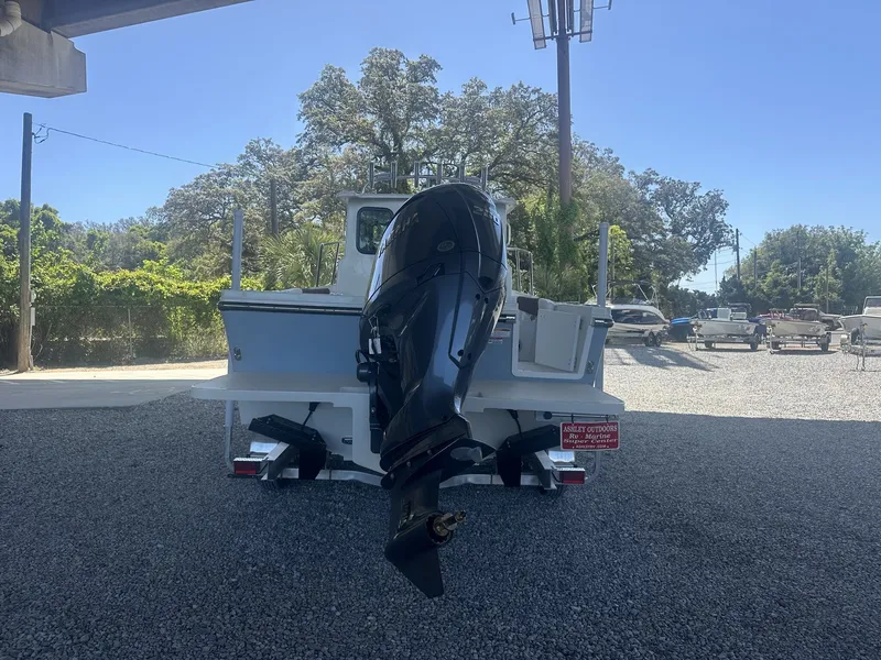 Slide: The Image of Parker 227 Explorer boat, 2026 model, with outboard motor outdoors. - 7