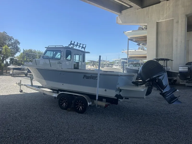 Slide: The Image of 2026 Parker 227 Explorer boat with trailer parked outdoors. - 8