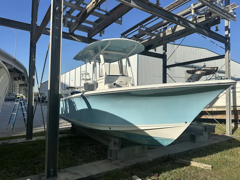 Slide: The Image of 2023 Sea Hunt Ultra 235 SE boat on a dry dock. - 2