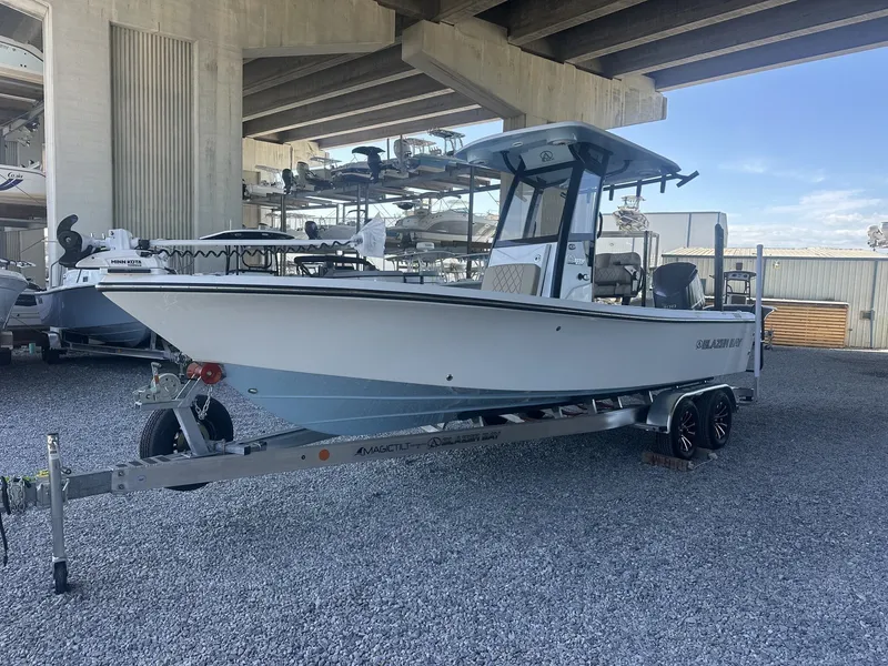 Slide: The Image of 2026 Blazer Bay 2440 boat on trailer under bridge. - 8