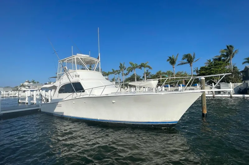 The Image of 1988 Post 46 Sportfish yacht docked in sunny marina with palm trees. - 0