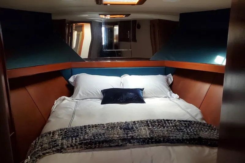 Slide: The Image of Luxurious cabin interior of 1988 Post 46 Sportfish yacht with cozy bedding. - 42
