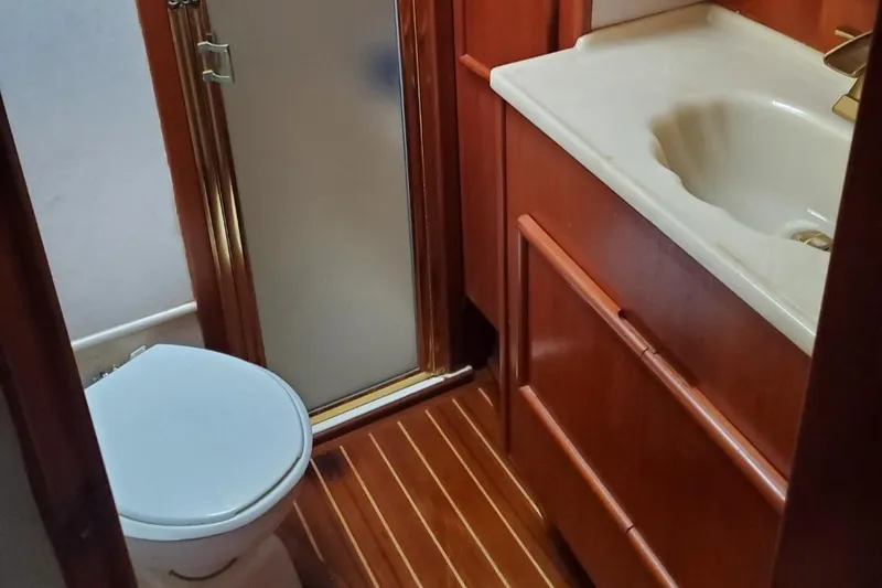 Slide: The Image of 1988 Post 46 Sportfish bathroom with shower, toilet, and wooden cabinetry. - 44