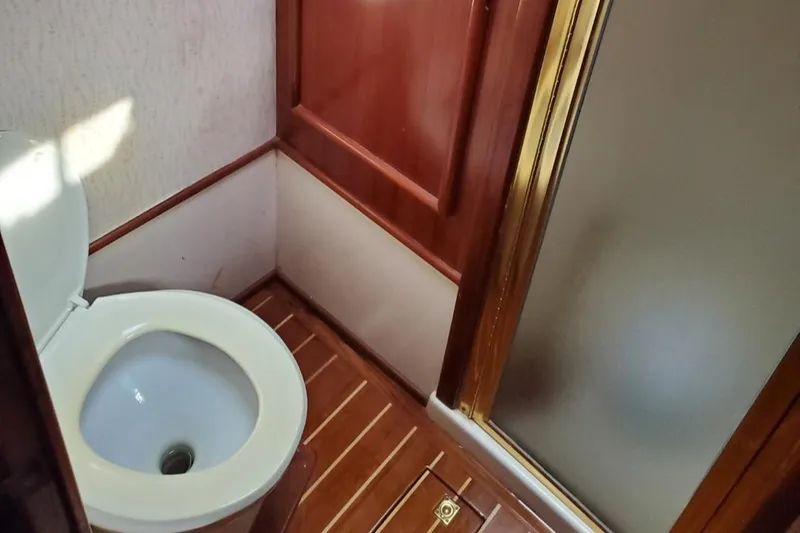 Slide: The Image of 1988 Post 46 Sportfish bathroom with wooden flooring and shower. - 48