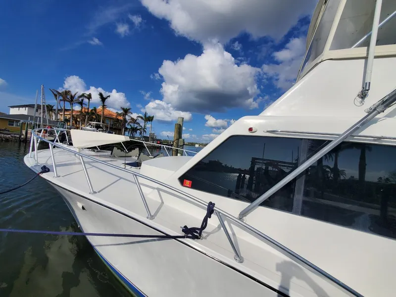 Slide: The Image of 1988 Post 46 Sportfish yacht docked under a clear blue sky. - 9