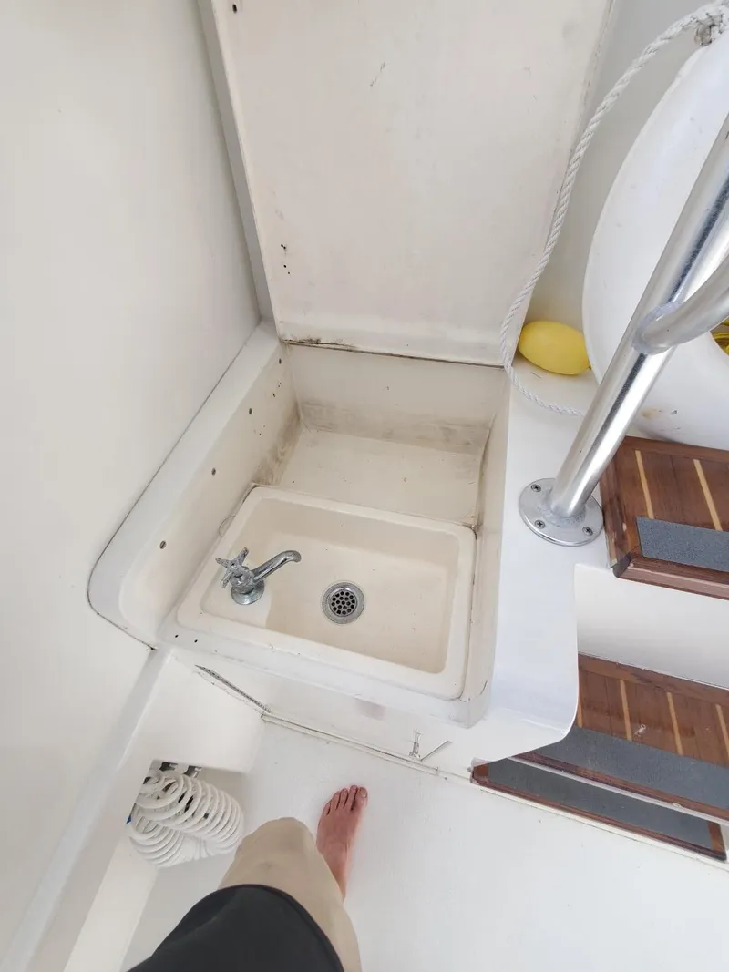 Slide: The Image of 1988 Post 46 Sportfish boat sink area with steps and railing. - 13
