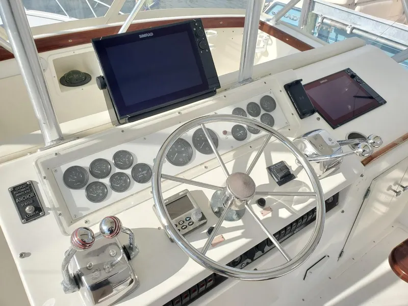 Slide: The Image of 1988 Post 46 Sportfish helm with steering wheel, gauges, and navigation screens. - 19