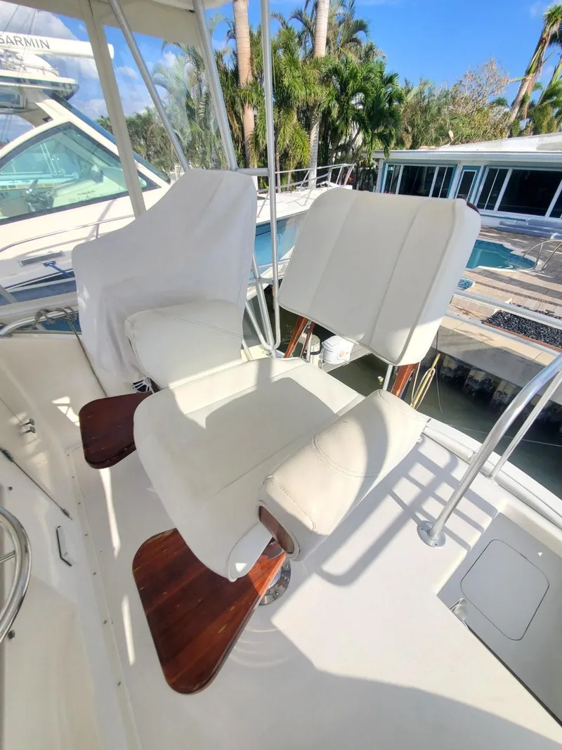 Slide: The Image of 1988 Post 46 Sportfish boat with white captain's chairs and wooden armrests. - 29