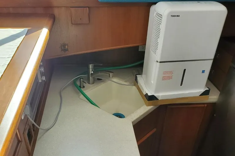 Slide: The Image of 1988 Post 46 Sportfish boat kitchen with sink and dehumidifier. - 39