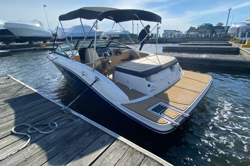 The Image of 2021 Sea Ray SPX 190 boat docked at marina, featuring sleek design and spacious deck. - 0