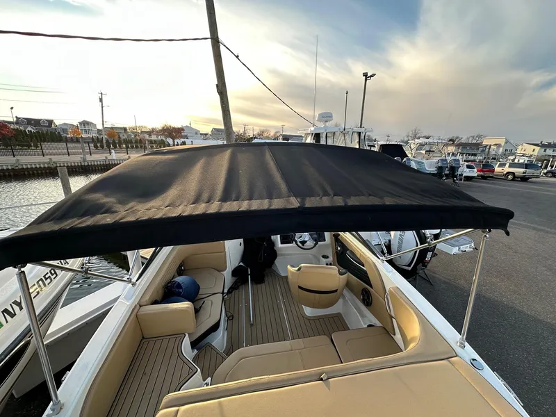 Slide: The Image of 2021 Sea Ray SPX 190 boat with black canopy at the dock. - 13
