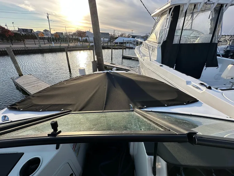 Slide: The Image of 2021 Sea Ray SPX 190 boat docked at marina during sunset. - 15