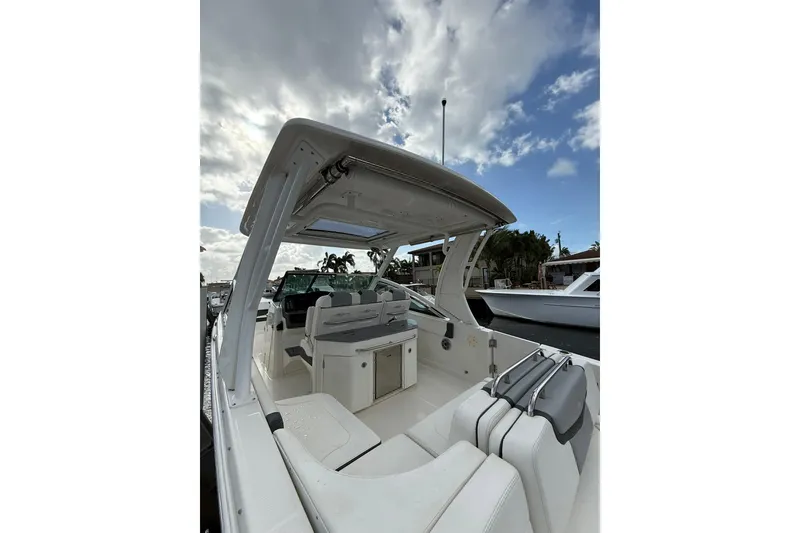 Slide: The Image of 2023 Chaparral 300 OSX boat interior with seating and open sky view. - 10