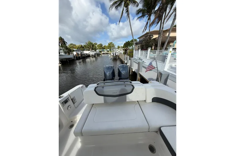 Slide: The Image of 2023 Chaparral 300 OSX boat docked, featuring dual engines and a serene waterfront view. - 22
