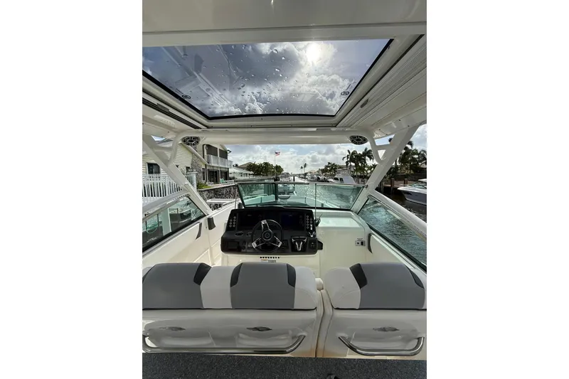 Slide: The Image of Interior view of 2023 Chaparral 300 OSX boat with modern helm and seating. - 24