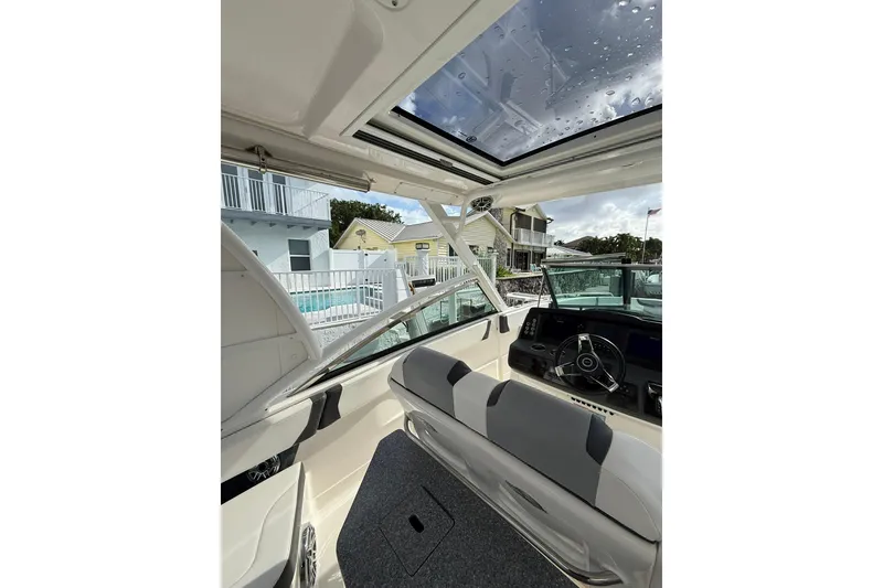 Slide: The Image of Interior view of 2023 Chaparral 300 OSX boat with modern helm and seating. - 25