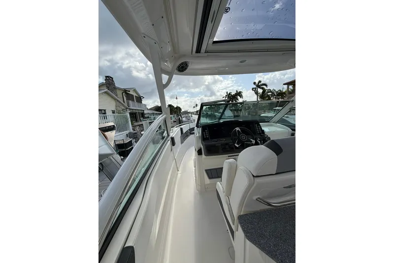 Slide: The Image of 2023 Chaparral 300 OSX boat interior with helm, sleek design, and modern features. - 26
