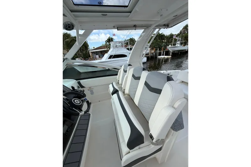 Slide: The Image of 2023 Chaparral 300 OSX boat interior with sleek seating and modern helm design. - 28