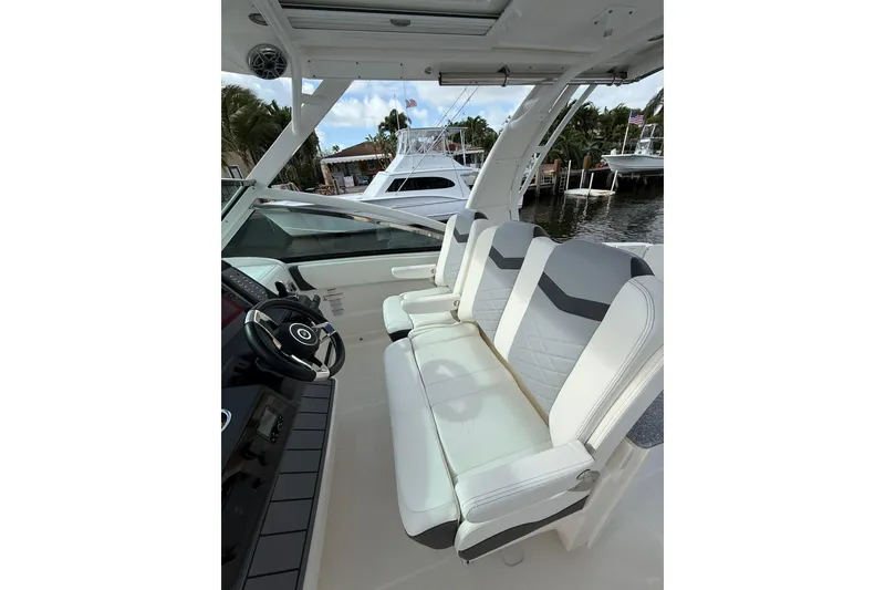 Slide: The Image of 2023 Chaparral 300 OSX boat interior with modern seating and steering wheel. - 29