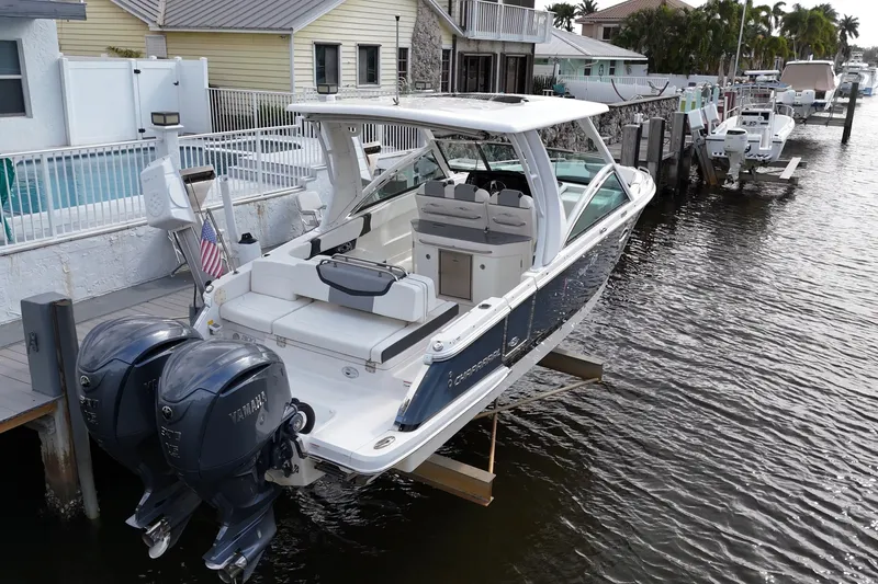 Slide: The Image of 2023 Chaparral 300 OSX boat docked with dual Yamaha engines. - 3