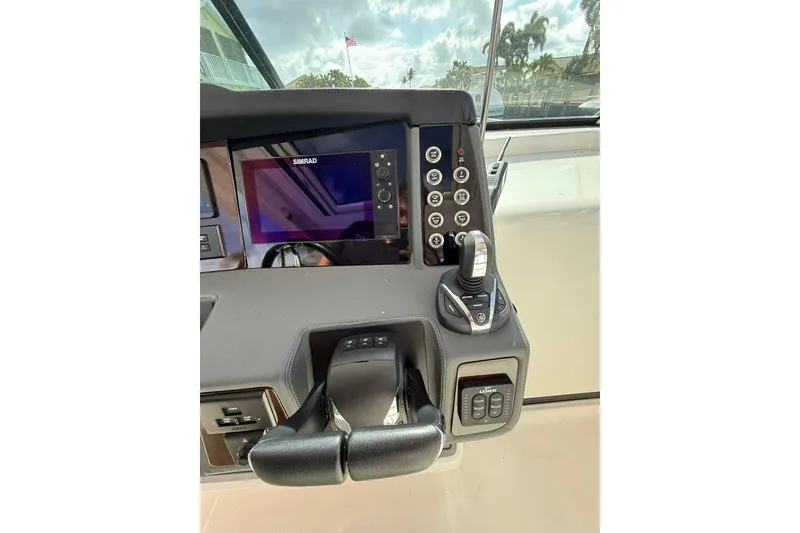 Slide: The Image of 2023 Chaparral 300 OSX helm with Simrad display and control panel. - 31