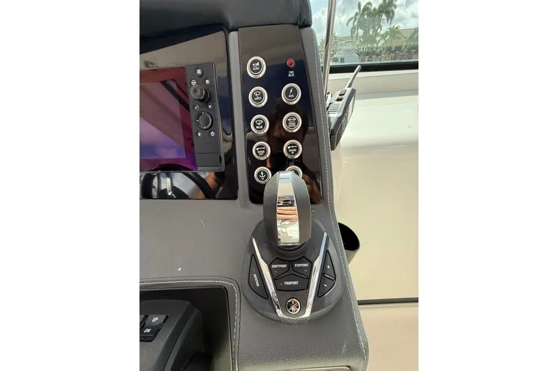 Slide: The Image of Control panel of 2023 Chaparral 300 OSX boat with joystick and buttons. - 32