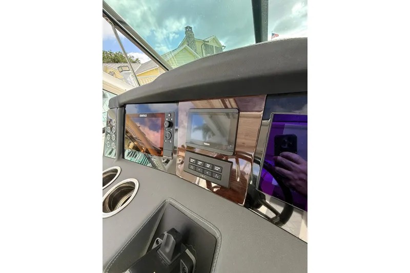 Slide: The Image of Dashboard of 2023 Chaparral 300 OSX boat with navigation and control panels. - 34