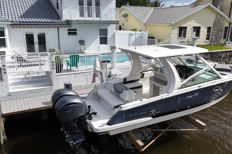 Slide: The Image of 2023 Chaparral 300 OSX boat docked near waterfront home with pool and patio. - 4
