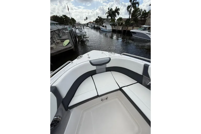 Slide: The Image of 2023 Chaparral 300 OSX boat interior with waterfront view and palm trees. - 43