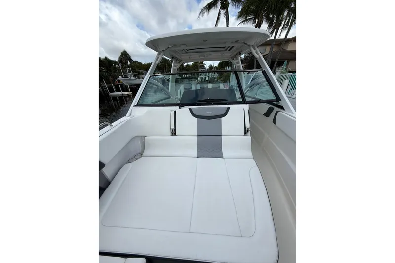 Slide: The Image of 2023 Chaparral 300 OSX boat interior with white seating and sleek design. - 48
