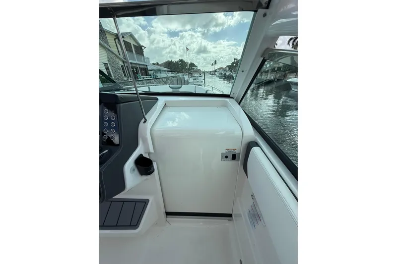 Slide: The Image of Interior view of 2023 Chaparral 300 OSX boat, showcasing sleek design and waterfront scenery. - 51