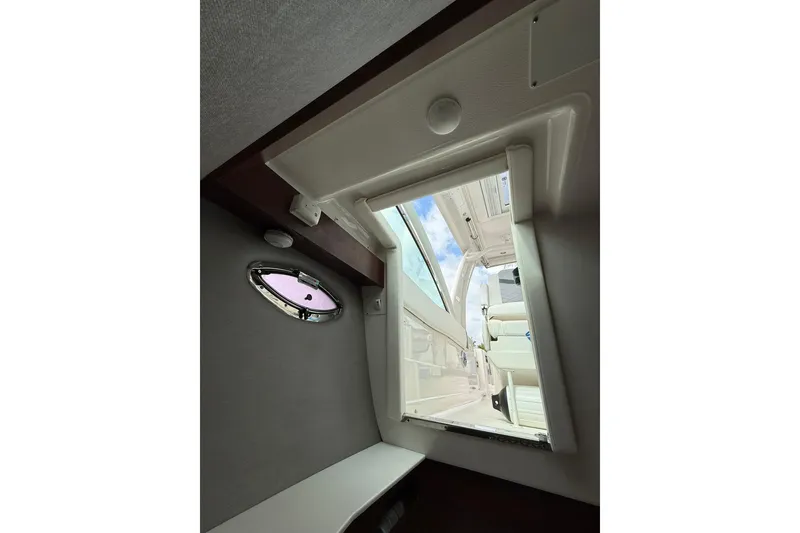 Slide: The Image of Interior view of 2023 Chaparral 300 OSX boat cabin with open hatch. - 59