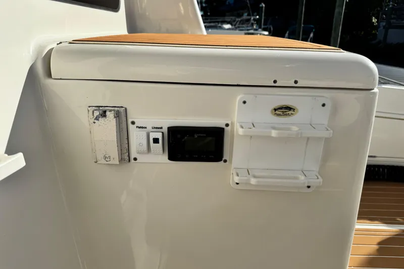 Slide: The Image of Control panel on a 2008 Silverton 42 Convertible yacht, featuring fishbox and livewell switches. - 12