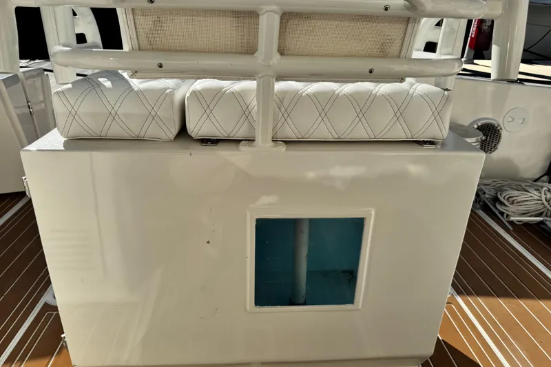 Slide: The Image of 2008 Silverton 42 Convertible boat interior with cushioned seating and storage compartment. - 14